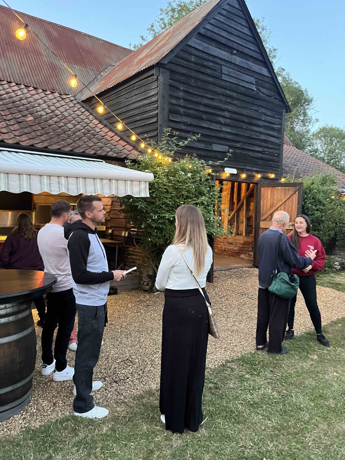 Delegates chatting outside the barns in the evening